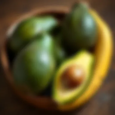 A bowl of avocados next to a banana for ripening