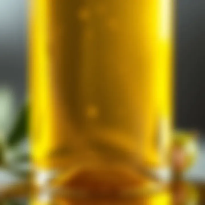A close-up of cold-pressed olive oil in a glass bottle illuminating its golden hue