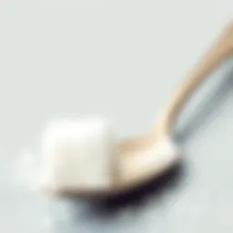 Sugar cube next to a teaspoon